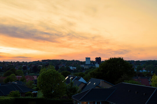 View of northern Haderslev, Denmark with Fulgsang's silos in the background and a light orange sky
