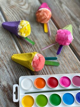 Ice cream from processing a cardboard box from eggs and a napkin painted with bright colors.