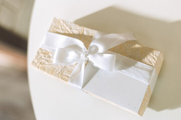 gift box wrapped in crumpled paper and tied with ribbon