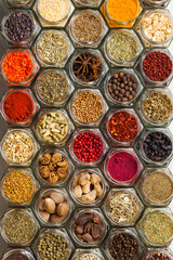 Top view of colourful spices in bottles like a pattern