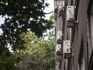 Air Conditioning Units, or AC, on display with their fans on a decaying facade of an old building of Belgrade, Serbia, Europe. They are used to cool down interiors, but consume a lot of electricity