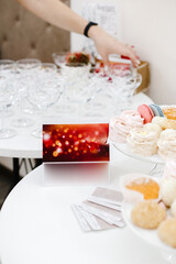 several empty glasses, plates with various cakes, advertising plates