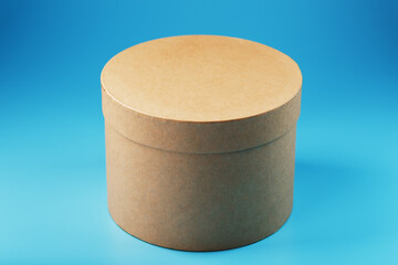 Round cardboard box on a blue background, free space.