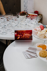 several empty glasses, plates with various cakes, advertising plates