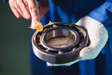 close up of a man holding a bearing
