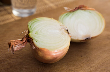 halves of ripe onions on wooden board