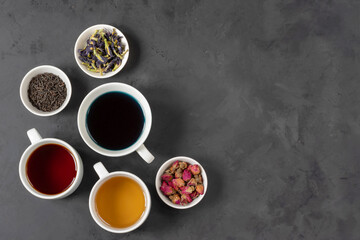 Obraz na płótnie Canvas Three cups of tea, from dried rosebuds, thai butterfly pea tea, black tea.