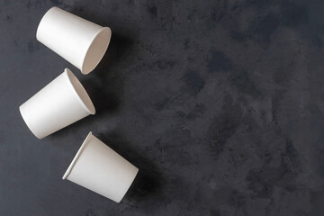 Paper white cups on a black background.