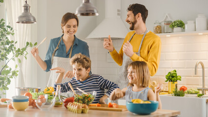 In Kitchen: Family of Four Cooking Together Healthy Dinner, Fool Around and Dance. Mother, Father,...