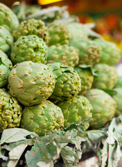 Fresh artichokes on market counter