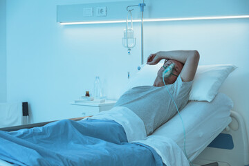 Patient sleeping and wearing an oxygen mask