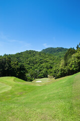 View of golf course in the mountains behind the sky