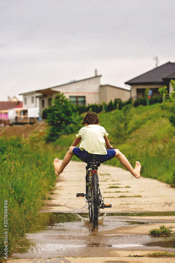 Sticker Child, boy, riding bike in muddy puddle, summer time