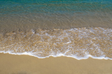 Tropical summer sandy beach & crystal clear blue water with soft white ocean wave