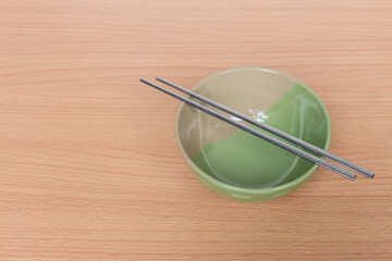chopsticks and bowl on bamboo mat