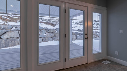 Fototapeta na wymiar Panorama Looking out through glass windows at snow