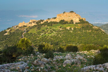Fototapeta na wymiar The Nimrod Fortress - remains of a medieval Ayyubid castle located on the southern slopes of Mount Hermon, overlooking the Golan Heights, lit up by morning sunlight; Northern Israel