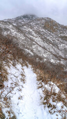 Vertical crop Snow dusted mountain scenery of Provo Canyon in Utah during winter season