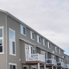 Square crop Townhouses exterior with small balconies at the facade in South Jordan Utah