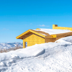 Square Home under construction on a mountain covered with snow in Park City Utah