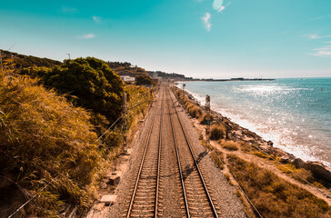 Train railway in front of the beach on a sunny day. 