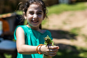 Little girl with a chameleon on her hands © Victor