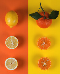 Bright colorful flat lay of tangerines and lemons, creative design background, top view