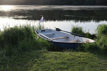 vintage boat with paddle at lake shore