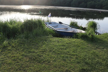 vintage boat with paddle at lake shore