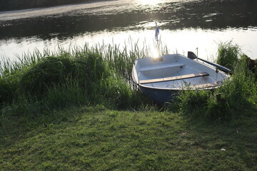 vintage boat with paddle at lake shore