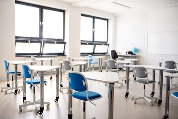 Desks in unconventional classoom in private school.