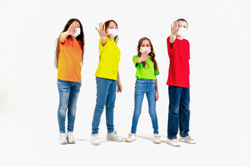 Group of schoolchildren children in colorful T-shirts and medical masks showing crossed hands gesture while looking at the camera over white background. Isolated. Stay at home. 