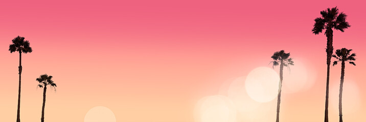 Silhouettes of Five Palm Trees in a Romantic Sunset with Bokeh