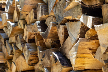 Chopped wood for lighting a fire is stacked in a woodpile, backgrounds and texture.