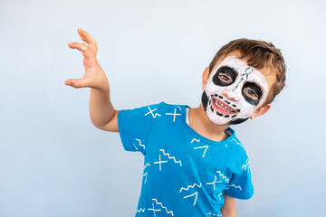 Arabic boy had a skull being draw on his face for halloween