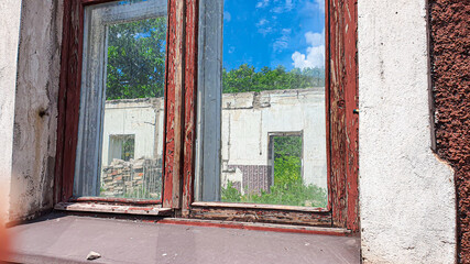 Fototapeta na wymiar Ruined old house. And the blue sky. The remains of old houses. Abandoned city. The city of ghosts. The ruins of old historic buildings destroyed by an earthquake.