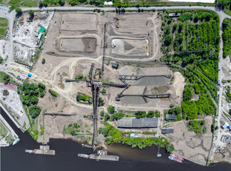 Aerial view of a sand and gravel processing plant near a river. Extraction, treatment and sale of...