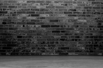 Black-gray room with a brick wall