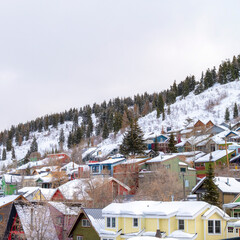 Square crop Park City residential community with colorful home cabins on snowy mountain
