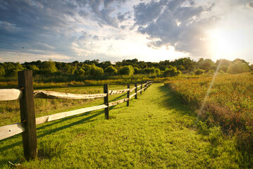The sun sets over a ranch fence in North Texas. - obrazy, fototapety, plakaty