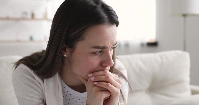 Head shot anxious young beautiful woman worrying about making doubtful hard decision. Close up nervous millennial girl waiting for news, thinking of problem solution, feeling jealous alone at home.