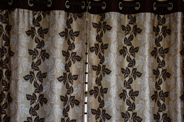 Picture of modern white color curtain with brown color printed flower design