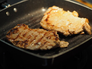 Pork Steak with Black Pepper and Pork sausage grilled on black pan food cooked for eat