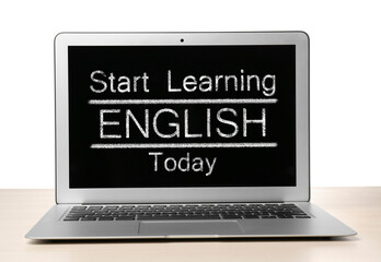 Modern laptop for online English learning on table against white background