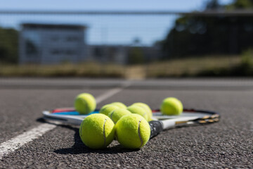 tennis racket on some balls