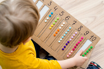 Preschool educational aid for kindergartens and home school. Put correct strap with balls of cotton...