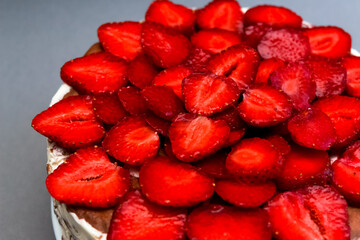 Delicious strawberry tart on white wooden background