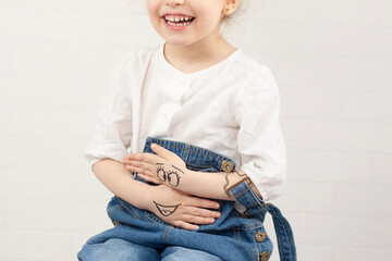 The girl has eyes and a smile on her hands. selective focus