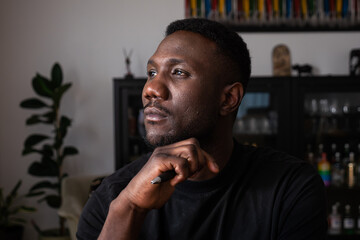Portrait of Black Man Thinking in Living Room