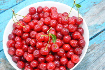 Tasty sweet ripe red cherries in a bowl as a concept of high quality vitamin food and healthy eating. Cherries background.
